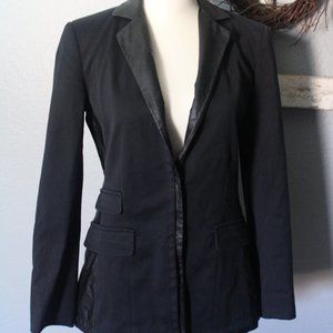black blazer with a leather detail.